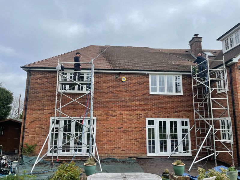 Roof cleaning carried out safely from scaffold towers by The Roof Moss Cleaners in How Wood